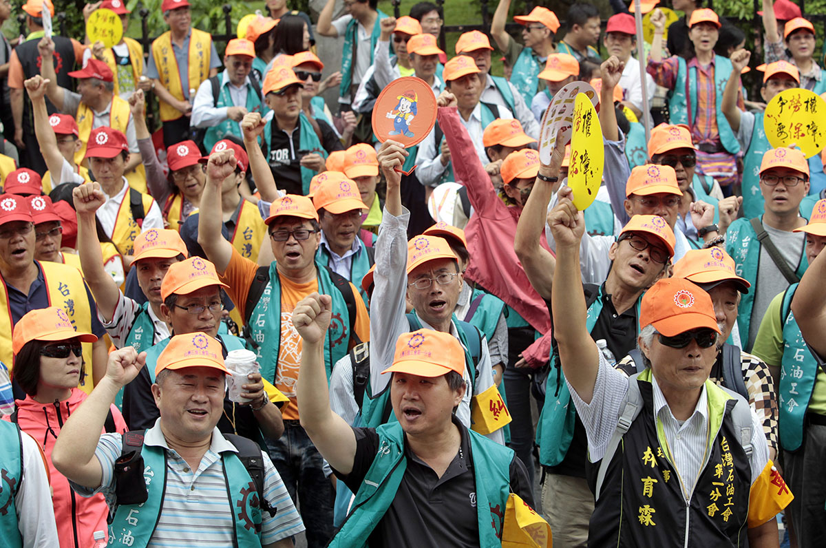Taiwanese workers shout slogans during a May Day rally in Taipei, Taiwan, Sunday, May 1, 2016. Thousands of protesters from different labor groups protest on the street to ask for raising minimum wage and shorter working hours.