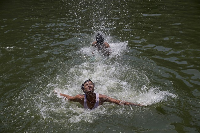 Indian boys swim at Hazrat Nizamuddin Baoli, a stepwell, on a hot day in New Delhi, India, Thursday, May 19, 2016. An intense heat wave continues to grip several parts of north India with most of the cities crossing the 40 degrees Celsius (104 degrees Fahrenheit) mark. (AP Photo/Tsering Topgyal).