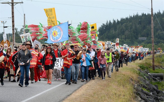 Protestors march near oil refineries in Anacortes, Wash., on Saturday, May 14, 2016. 