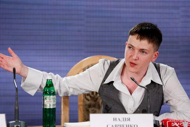 Ukrainian pilot Nadezhda Savchenko, who was freed from a Russian jail, gestures while speaking to the media during her news conference in Kiev, Ukraine, Friday, May 27, 2016. Savchenko, who came home on Wednesday after two years in Russian custody says she would run for president if that's what Ukrainians desire. (AP Photo/Sergei Chuzavkov).