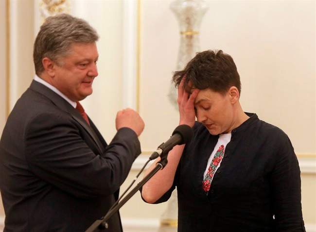 Ukrainian President Petro Poroshenko, left, looks at Ukrainian jailed pilot Nadezhda Savchenko during their meting in the Presidential Office in Kiev, Ukraine, Wednesday, May 25, 2016. Russia has released jailed pilot Nadezhda Savchenko, as part of a swap for two Russian servicemen imprisoned in Ukraine. (AP Photo/Efrem Lukatsky).