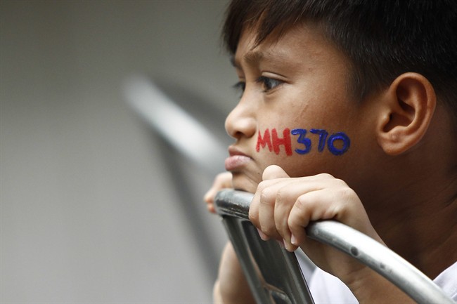 In this photo taken on Sunday, March 6, 2016, a Malaysian child with his face painted with MH370 during a remembrance event for the ill fated Malaysia Airlines Flight 370 in Kuala Lumpur, Malaysia.