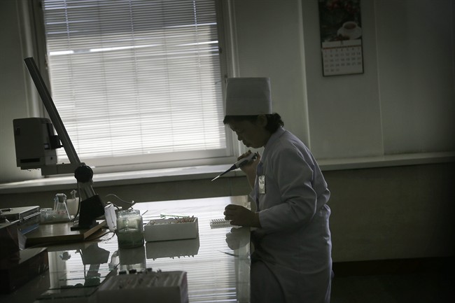 A staff member does lab work in the research department of the Pyongyang Maternity Hospital during a press tour on Saturday, May 7, 2016 in Pyongyang, North Korea. 