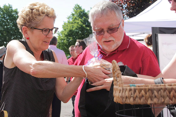 Liberal Leader Kathleen Wynne is seen at a farmer's market in Waterdown, Ont., on Saturday, June 7, 2014 with local Liberal member Ted McMeekin.