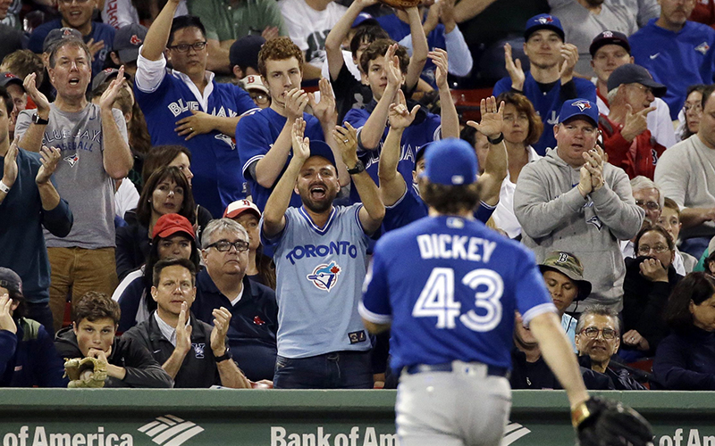 Toronto Blue Jays starting pitcher R.A. Dickey is cheered by Blue Jays fans as he leaves the game in the seventh inning of a baseball game against the Boston Red Sox at Fenway Park, Friday, June 3, 2016, in Boston. 