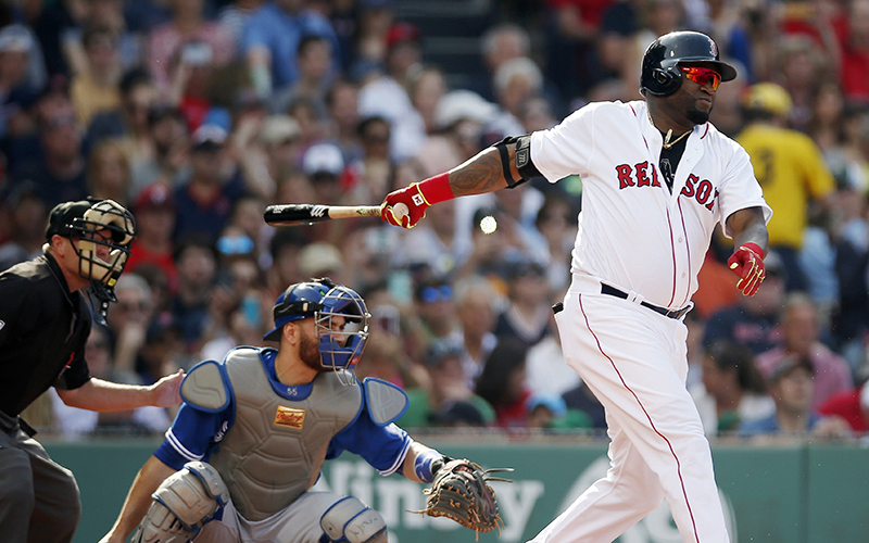 Boston Red Sox's David Ortiz, right, follows through on a two-run single in front of Toronto Blue Jays' Russell Martin during the third inning of a baseball game Saturday, June 4, 2016, in Boston. 