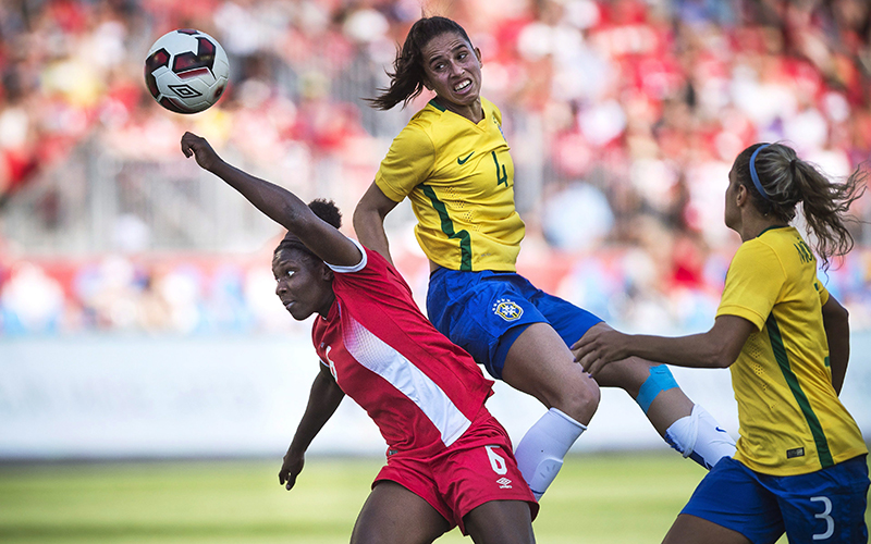 Canada's Deanne Rose collides with Brazil's Rafaelle during first half in a friendly match for the Road To Rio in Toronto, Saturday, June 04, 2016. 