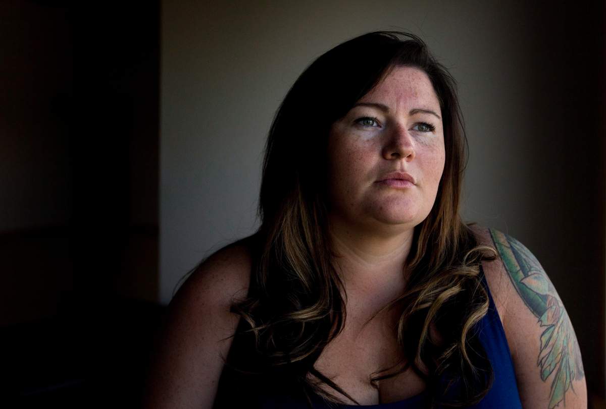 Claire Woodall, widow of Edmonton police Const. Dan Woodall, speaks with media on the anniversary of her husband's shooting death, in Edmonton Alta, on Monday June 6, 2016. Const. Dan Woodall a 35-year-old Edmonton Police Service officer in the hate crimes unit, was shot to death in a west Edmonton suburb in June of 2015. 