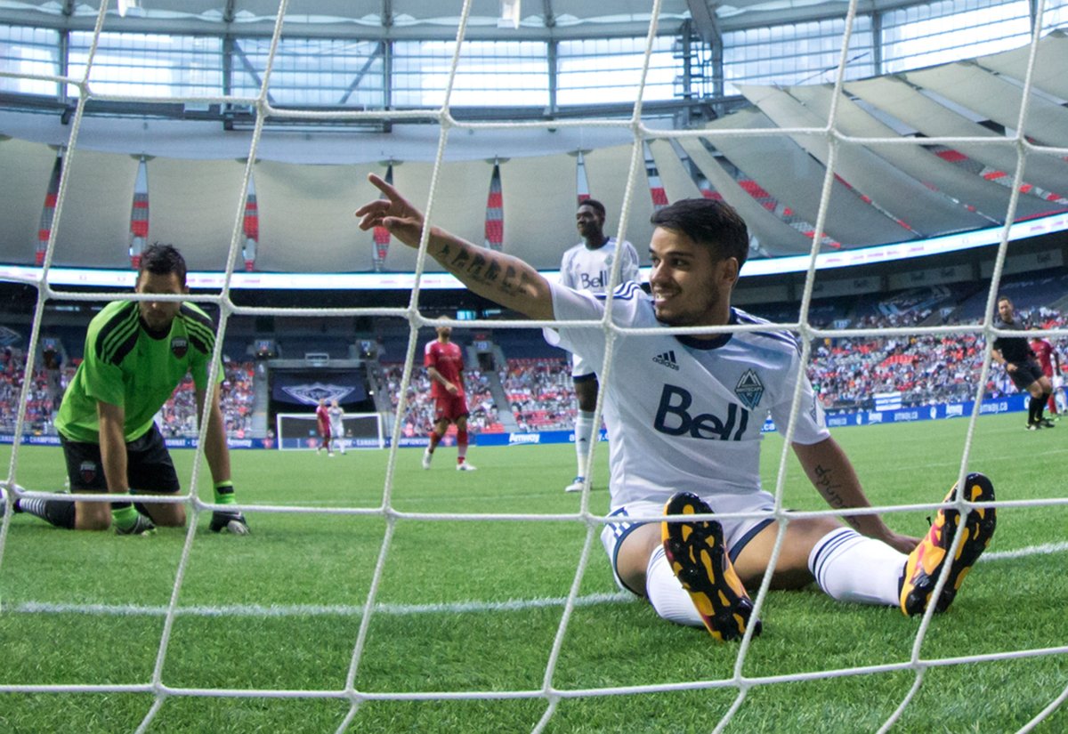 Vancouver Whitecaps' Cristian Techera, right, sits in the net behind Ottawa Fury goalkeeper Romuald Peiser, left, after failing to connect with a pass during second half semifinal Canadian Championship soccer action in Vancouver, B.C., on Wednesday June 8, 2016. 