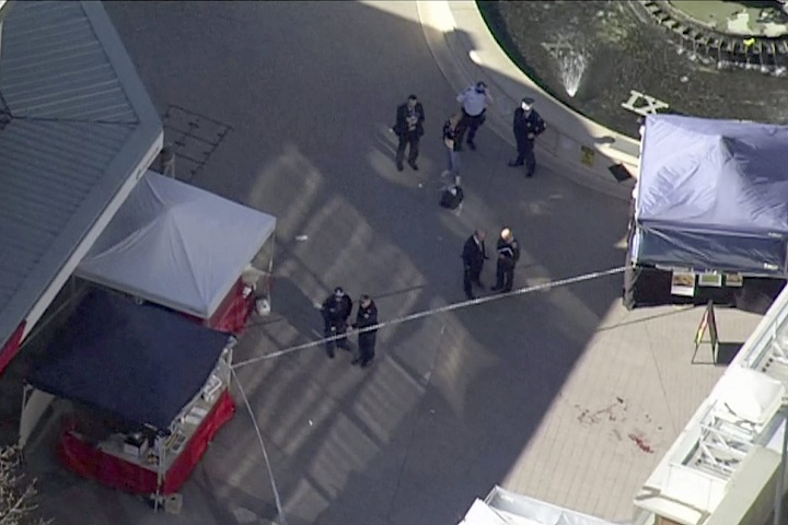 In this aerial image made from video provided by Australian Broadcasting Corporation, police investigate the scene at a shopping mall in Sydney Thursday, June 9, 2016. Police officers opened fire on a man armed with a carving knife in a Sydney shopping mall on Thursday, wounding the man and three women aged between 60 and 80, police said. (Australian Broadcasting Corporation via AP).