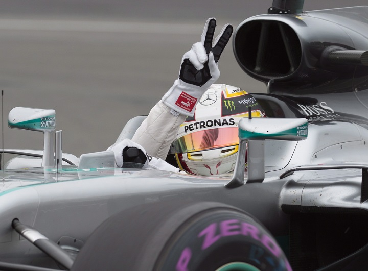 Mercedes driver Lewis Hamilton of Great Britain waves to the fans after winning the pole position in the qualifying session, Saturday, June 11, 2016 at the Canadian Grand Prix in Montreal. THE CANADIAN PRESS/Jacques Boissinot