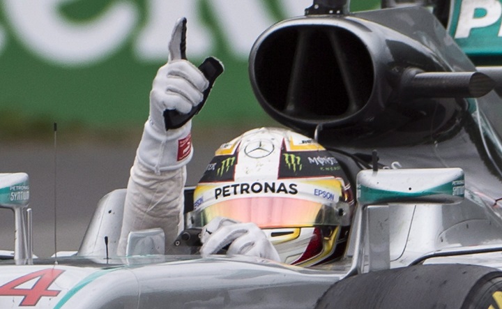 Mercedes driver Lewis Hamilton of Great Britain signals after winning the Canadian Grand Prix in Montreal, Sunday, June 12, 2016. THE CANADIAN PRESS/Graham Hughes