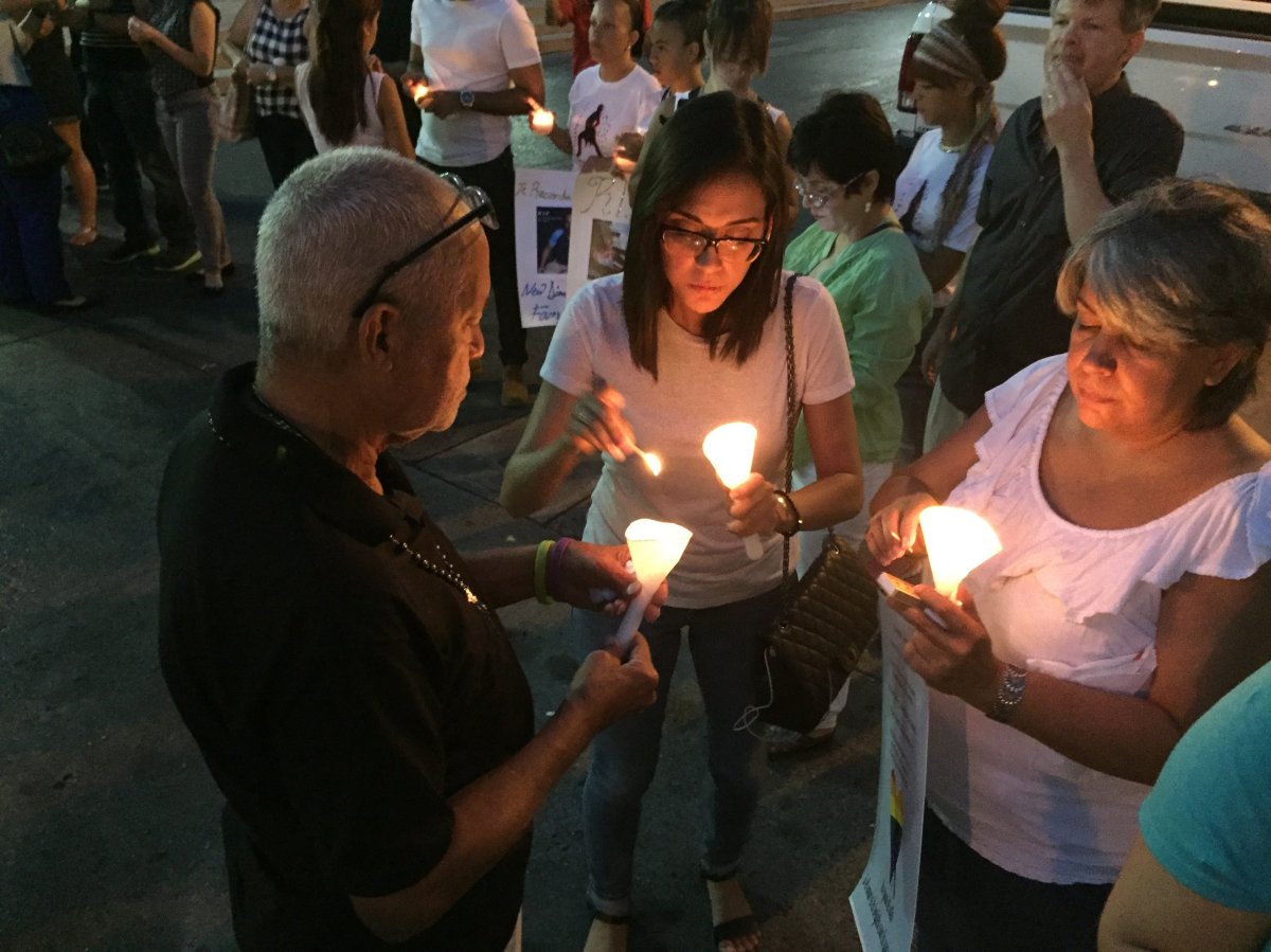 People light candles in Ponce, Puerto Rico, Monday, June 13, 2016, during a vigil for the victims of Sunday's Orlando shootings at a gay nightclub in Florida. At least 5 of the 49 victims were from Ponce, the second largest city on Puerto Rico's souther coast.