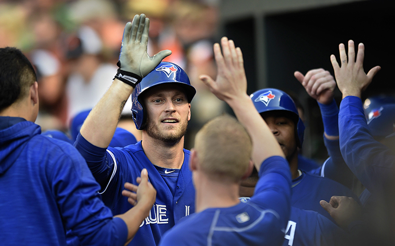 Toronto Blue Jays' Michael Saunders, center, is congratulated after hitting a three-run home run against the Baltimore Orioles in the first inning of a baseball game, Friday, June 17, 2016, in Baltimore. 