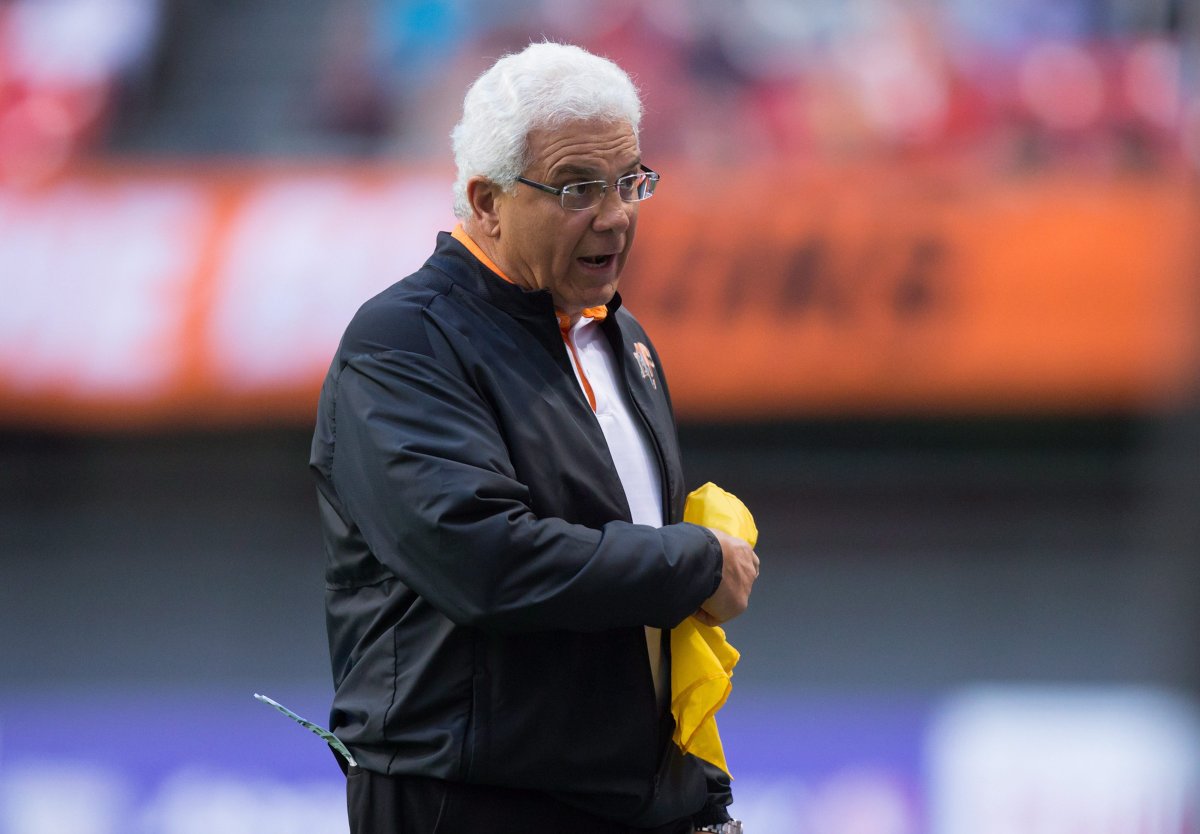B.C. Lions' head coach Wally Buono carries a challenge flag after throwing it during the first half of a pre-season CFL football game against the Calgary Stampeders in Vancouver, B.C., on Friday June 17, 2016. 