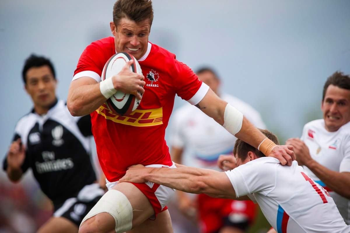 Russia's Kushnarev Yury, right, grabs Canada's Matt Evans during an international rugby match in Calgary, Alta., Saturday, June 18, 2016.