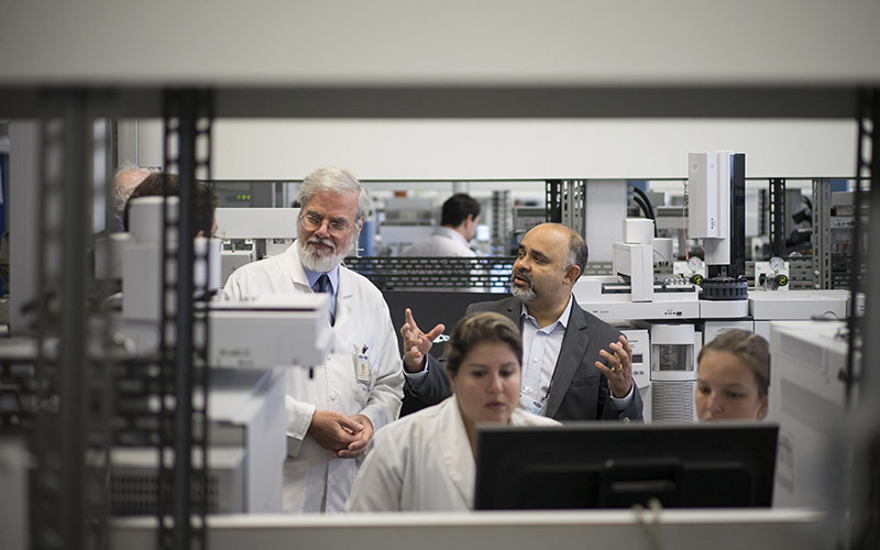 Brazil's Sports Minister George Hilton, top right, and Professor Francisco Radler, left, talk during Hilton's visit to the Brazilian Doping Control Laboratory (LBCD) in Rio de Janeiro, Brazil. 