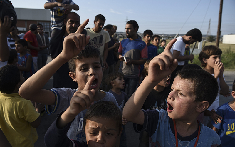 Migrants and refugees chant slogans during a protest against the living conditions at the Oreokastro camp, near the northern town of Thessaloniki, Greece, on Saturday, June 25, 2016. 