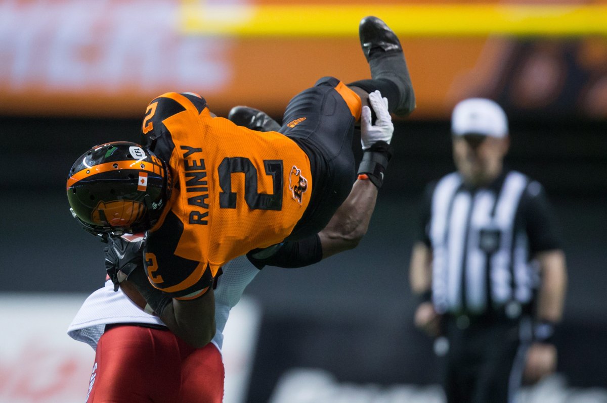 B.C. Lions' Chris Rainey is upended by Calgary Stampeders' Brandon Smith, back, after making a reception during the second half of a CFL football game in Vancouver, B.C., on Saturday June 25, 2016. 