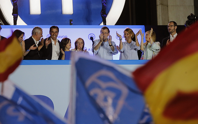 Spain's acting Primer Minister and candidate of Popular Party Mariano Rajoy, center, celebrates with party members the results of their party, during the national elections in Madrid, Spain, Sunday, June 26, 2016. 