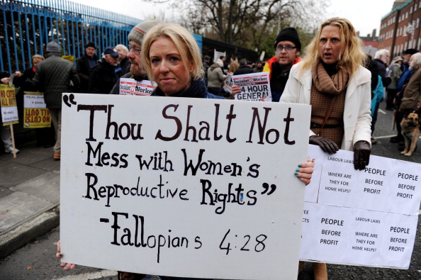 A protestor displays a banner against Ireland's abortion laws during a march against Government austerity measures in Dublin, Ireland on November 24, 2012. 