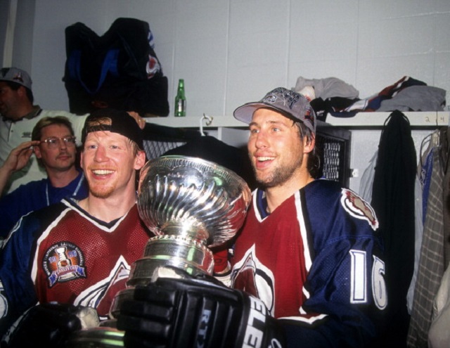 Mike Keane (left) and Warren Rychel hold the Stanley Cup in the locker room after the Colorado Avalanche defeated the Florida Panthers in Game 4 of the 1996 Stanley Cup Finals.