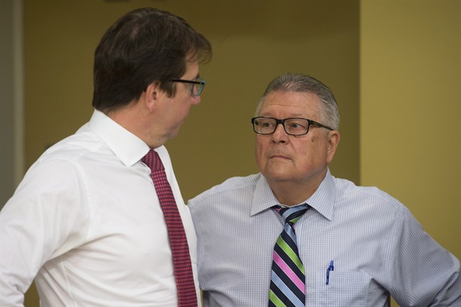 Treasury Board President Scott Brison (left) speaks with Public Safety and Emergency Preparedness Minister Ralph Goodale before appearing before the National Security and Defence Committee in Ottawa, on Monday, June 6, 2016.