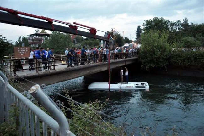 Turkish rescuers lift a bus from a canal near Osmaniye, Turkey, Monday, June 6, 2016. 