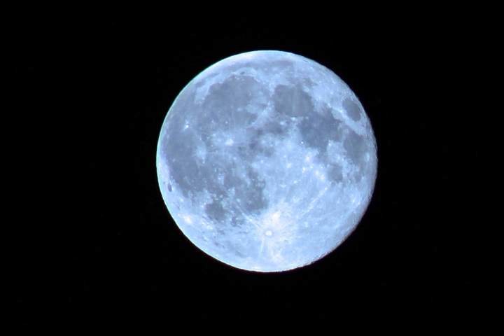 Blue moon captured by Silver Falls, Man.
