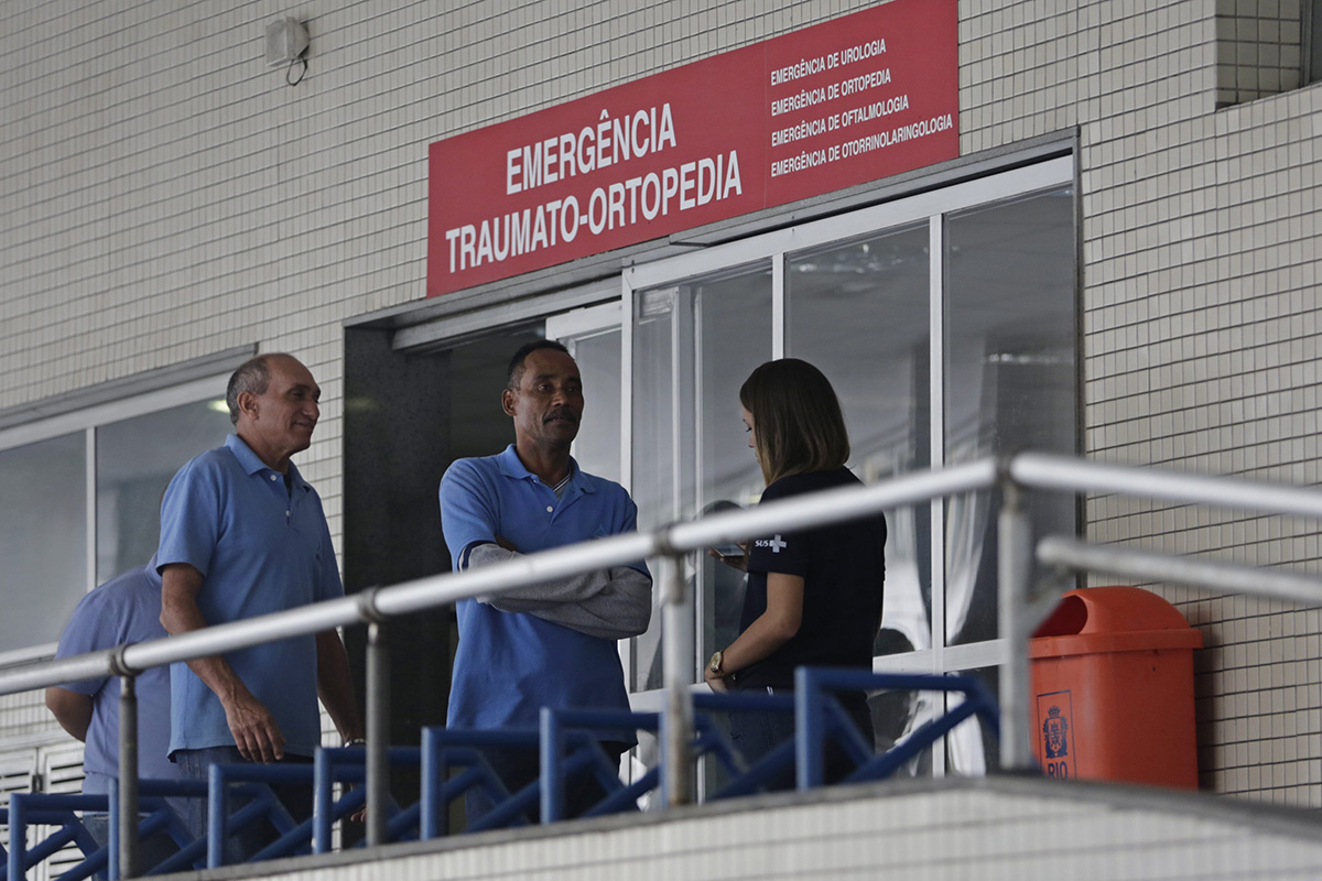 Employees stand in front an emergency entrance at the Souza Aguiar Hospital, in Rio de Janeiro, Brazil, Sunday, June 19, 2016. 