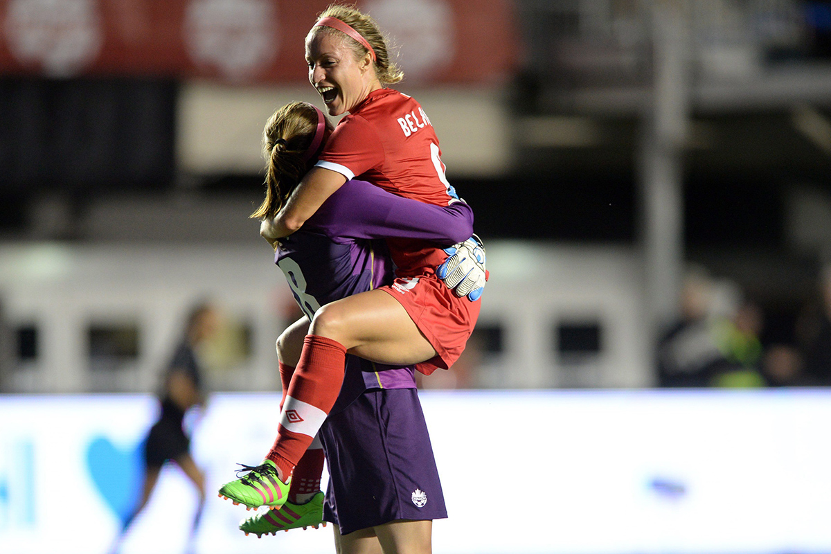 Canada's Josee Belanger jumps into goalkeeper Stephanie Labbe arms after scoring the game winning goal against Brazil.