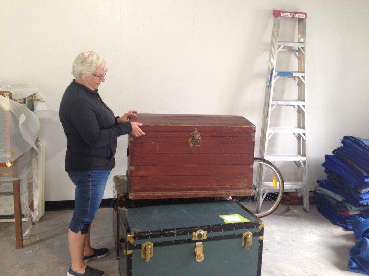 Jenny Palmer looks at her great-grandparents’ old trunk brought to Canada from Russia. It was saved after the explosion, but the contents–her kids’ baby clothes– weren’t.