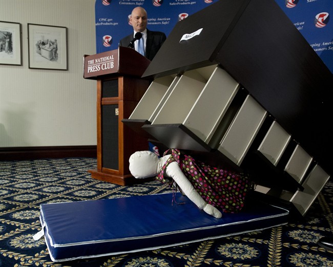 Consumer Product Safety Commission (CPSC) Chairman Elliot Kaye watches a demonstration of how an Ikea dresser can tip and fall on a child during a news conference at the National Press Club in Washington, Tuesday, June 28, 2016.