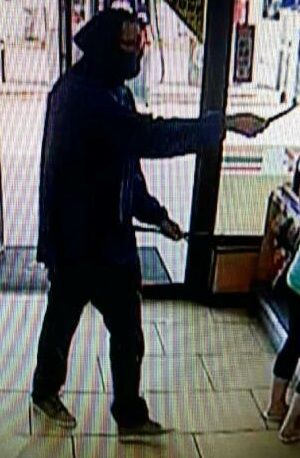 A man points what police believe is a knife during a robbery at a Cold Lake 7 Eleven, Monday, June 6, 2016. 