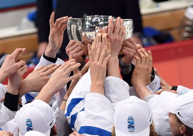 Finland players reach for the trophy as they celebrate their gold medal game win at the IIHF World Junior Championship in Helsinki, Finland on Tuesday, Jan 5, 2016.