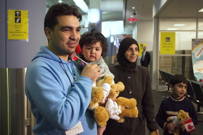 A family of Syrian refugees arrive at the Welcome Centre at Toronto's Pearson Airport on Friday December 18, 2015.