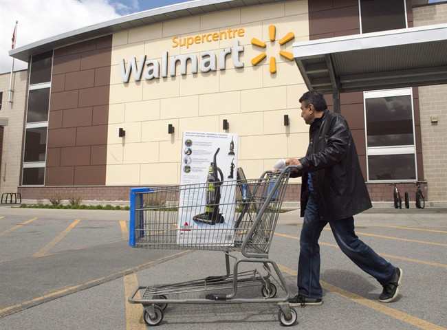 A customer leaves a Walmart store in Laval, Que., on Tuesday, May 3, 2016. Visa is accusing Walmart of using consumers as pawns in its battle to save costs by threatening to ban the popular credit card from its Canadian stores.