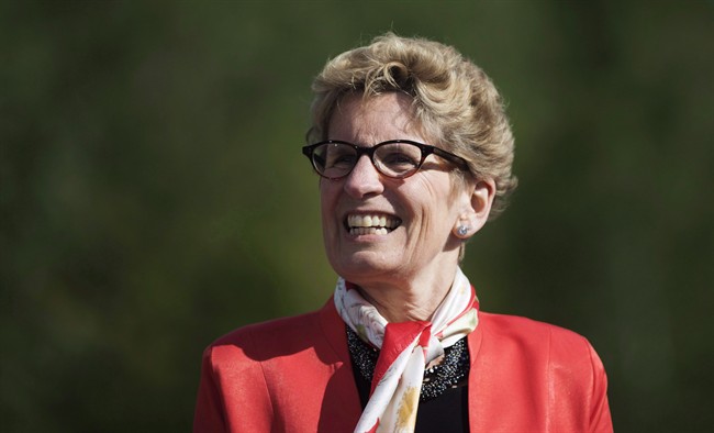 Ontario Premier Kathleen Wynne looks on before making a climate change policy announcement at Evergreen Brickworks in Toronto, Wednesday, June 8, 2016.