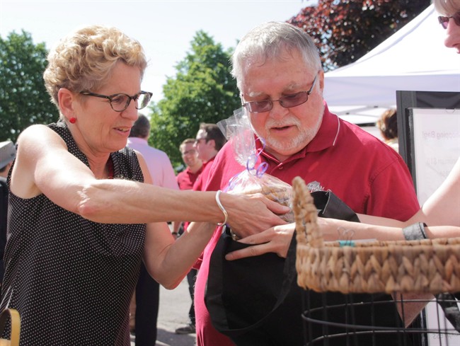 Liberal Leader Kathleen Wynne is seen at a farmer's market in Waterdown, Ont., on Saturday, June 7, 2014 with local Liberal member Ted McMeekin as she campaigns for the June 12 election.