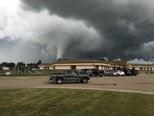 A funnel cloud is seen touching down in the town of Ponoka, Alta., on June 30, 2016.