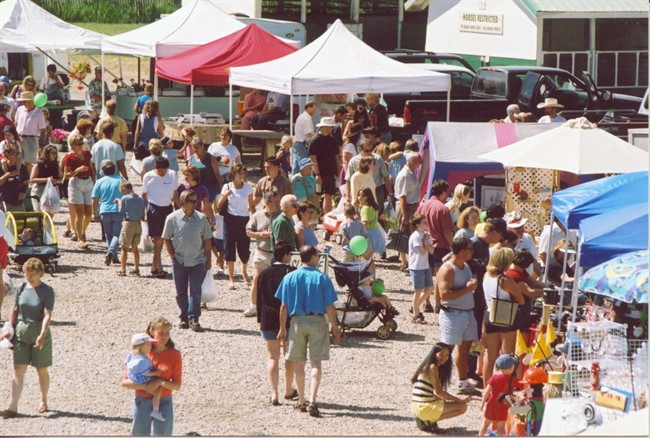 People shop at various vendors at the Millarville farmers' market South of Calgary.