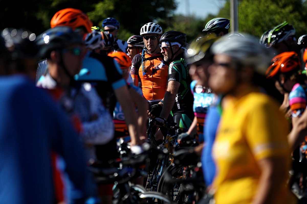 Hundreds bikers stand before a silent bike ride in Kalamazoo, Mich., Wednesday, June 8, 2016, to supporting the cyclists who were killed and injured in a crash the day before.