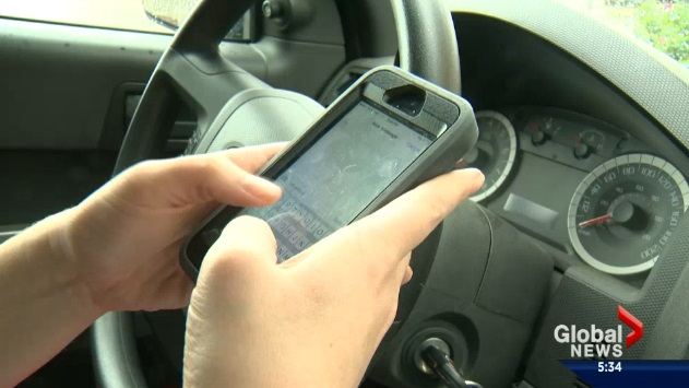 File: A photo of a person distracted while driving.