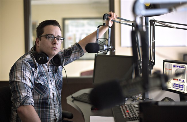 Andrew Wilcox, program director at 100.5 Cruz FM, pictured in Fort McMurray Alta, on Saturday June 4, 2016. From the streetfront window of rock station Wilcox can see the forested hill where his home still stands in the fire-scarred Abasand neighbourhood. 