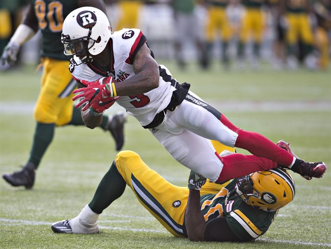 Ottawa Redblacks Travon Van (3) is tackled by Edmonton Eskimos Deon Lacey (40) during second half CFL action in Edmonton, Alta., on Saturday, June 25, 2016. 