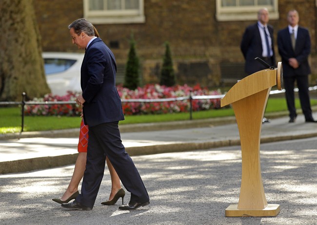 In this Friday, June 24, 2016 file photo, Britain's Prime Minister David Cameron and his wife Samantha walk back into 10 Downing Street, London, after speaking to the media. Cameron says he will resign by the time of the party conference in the fall after Britain voted to leave the European Union after a bitterly divisive referendum campaign, according to tallies of official results Friday.