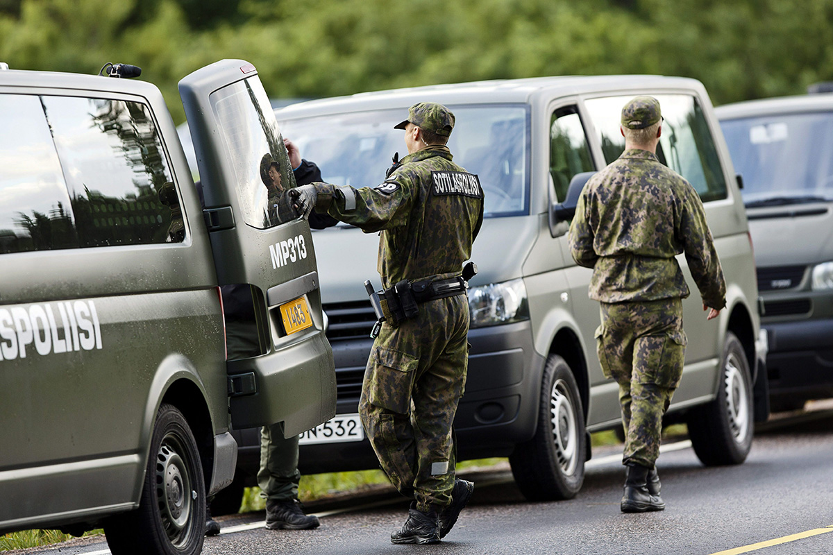 Military police officers attend the scene of a deadly shooting in Vihti, Finland Saturday, June 18, 2016.