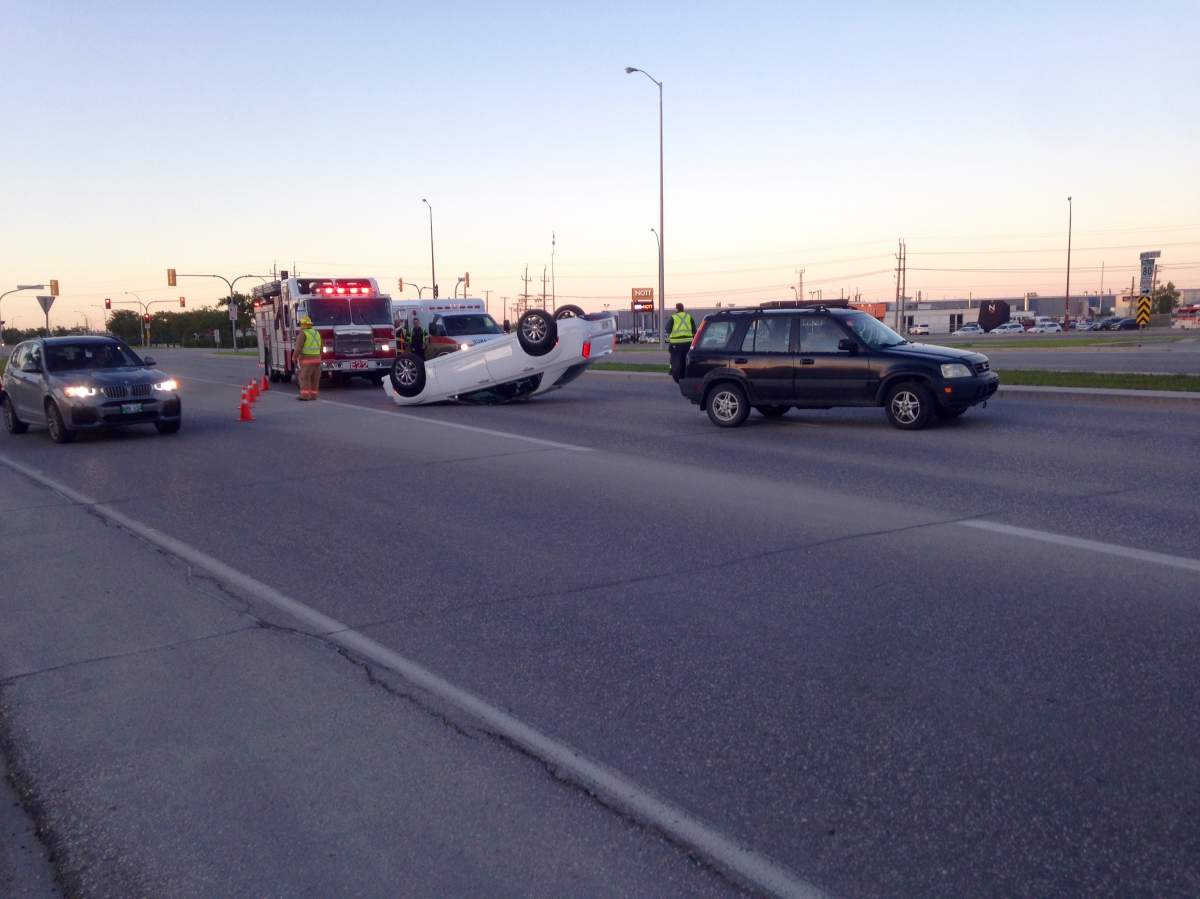 A white car lies on its roof near the intersection of McGillvray Blvd and Waverley Street Monday evening.