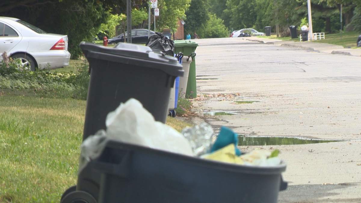Trash sits on the roadside for bi-weekly pick-up in Pointe-Claire, Wednesday, June 29, 2016.