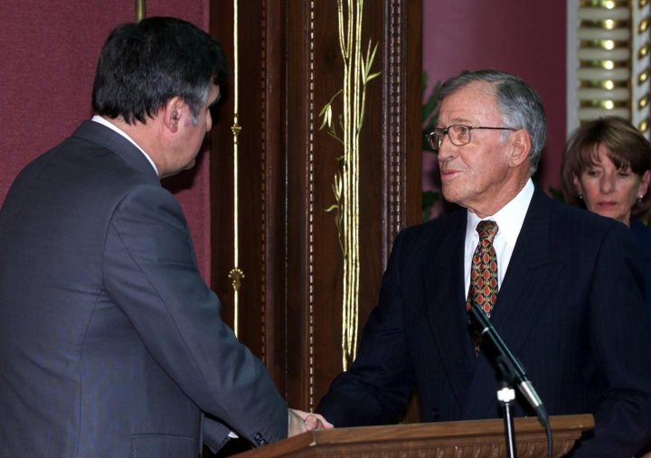 Quebec Premier Lucien Bouchard, left, decorates former Quebec City mayor, Tory cabinet minister and Lt. governor Gilles Lamontagne with the Order National du Quebec, Thursday May 25, 2000, at the legislature in Quebec City.